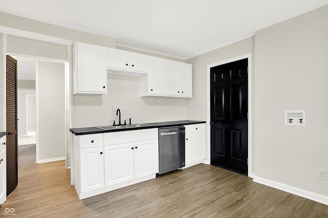 kitchen featuring light hardwood / wood-style flooring, white cabinetry, stainless steel dishwasher, and sink