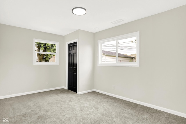 unfurnished bedroom with light carpet and a closet