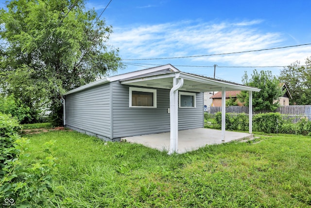 view of property exterior featuring a yard and a patio area