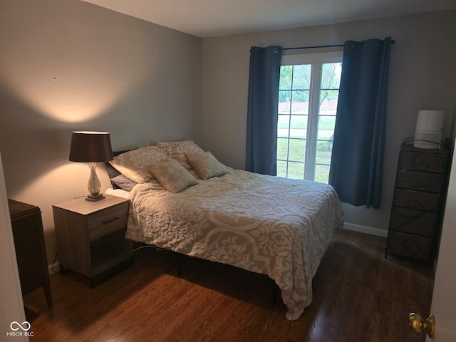 bedroom with dark wood-type flooring