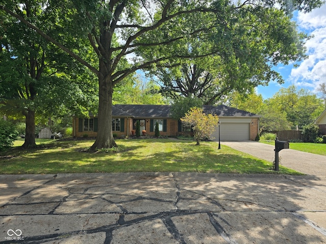 ranch-style house featuring a garage and a front lawn