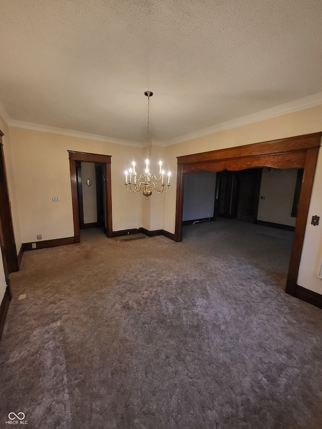 unfurnished dining area featuring a textured ceiling, ornamental molding, dark carpet, and a chandelier