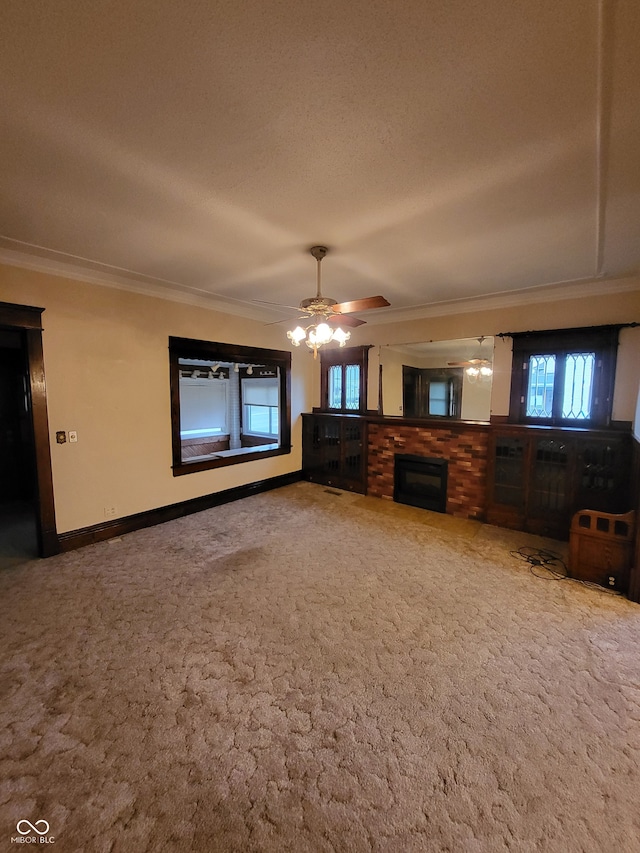 unfurnished living room featuring ornamental molding, ceiling fan, carpet flooring, and a textured ceiling