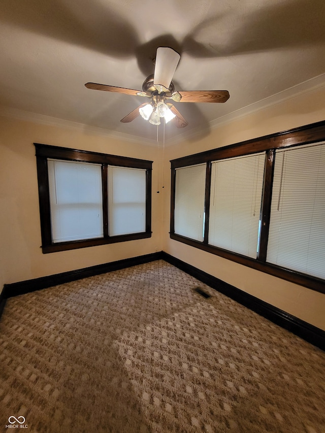 carpeted empty room featuring crown molding and ceiling fan