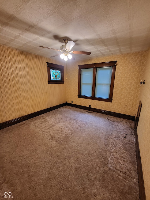 spare room with ceiling fan and carpet floors