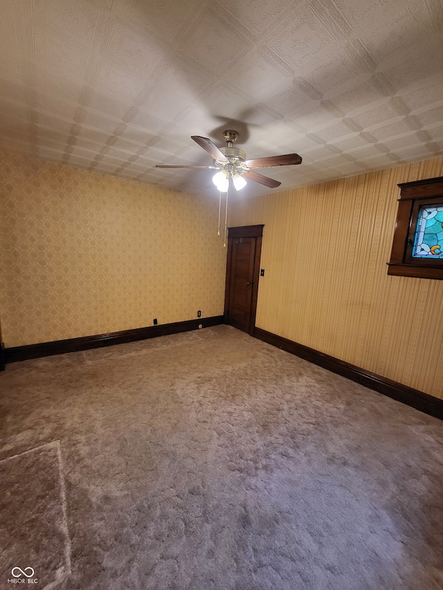 carpeted spare room with ceiling fan