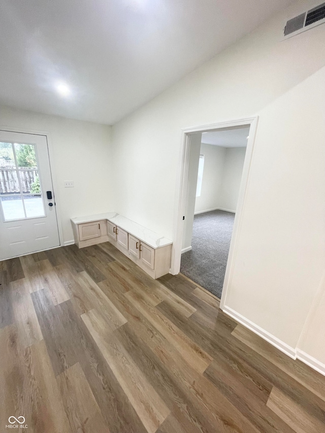 empty room featuring lofted ceiling and dark hardwood / wood-style floors