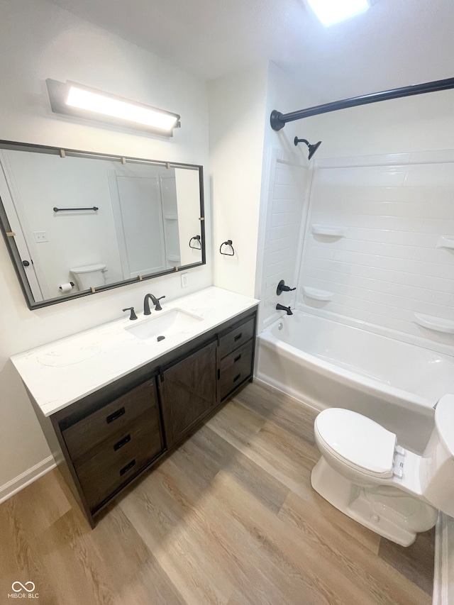 full bathroom with wood-type flooring, shower / bathtub combination, vanity, and toilet