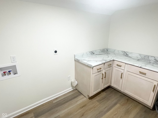 laundry area with washer hookup, cabinets, hardwood / wood-style floors, and hookup for an electric dryer