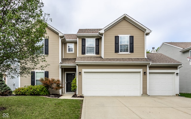 view of front of house with a front lawn and a garage