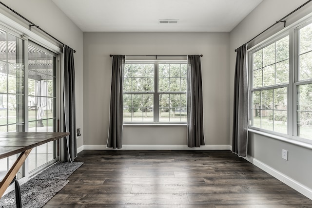 empty room with dark hardwood / wood-style floors