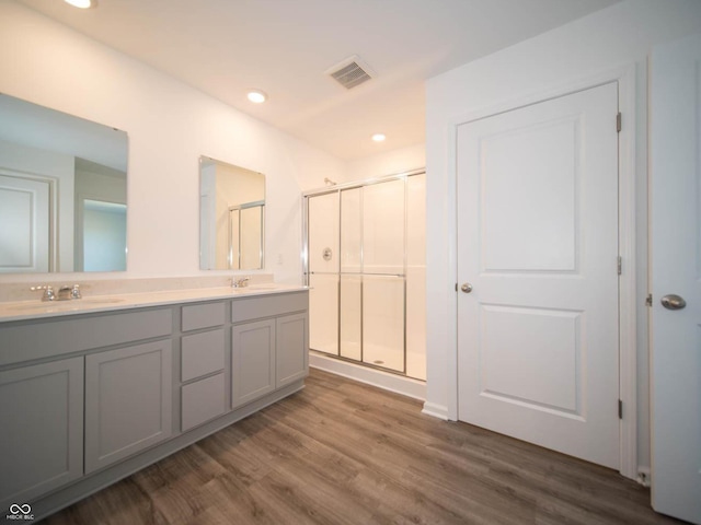 7888 Magnolia St, New Palestine, IN 46163 - bathroom featuring double vanity, a shower stall, wood finished floors, and recessed lighting