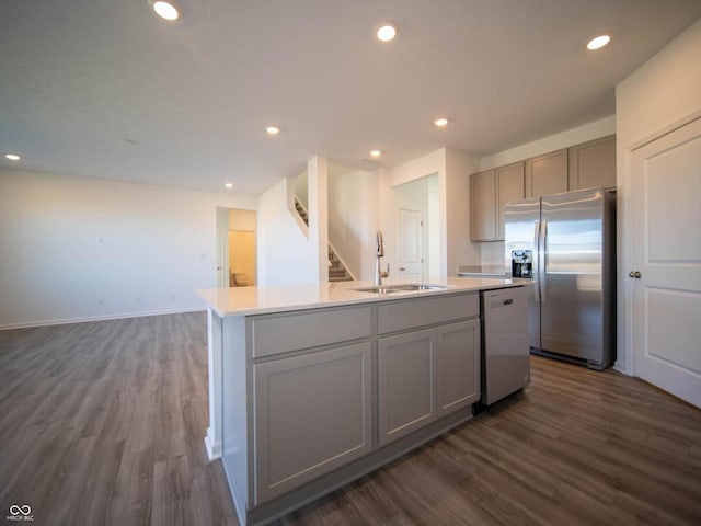 7888 Magnolia St, New Palestine, IN 46163 - kitchen featuring appliances with stainless steel finishes, gray cabinets, dark wood-style flooring, a kitchen island with sink, and recessed lighting