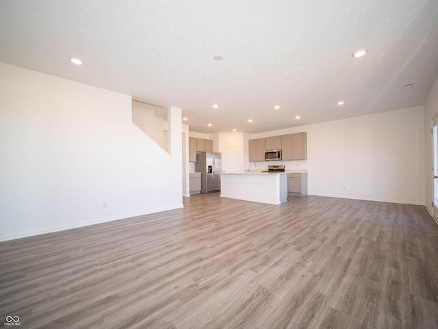 7888 Magnolia St, New Palestine, IN 46163 - unfurnished living room with light wood-style flooring and recessed lighting