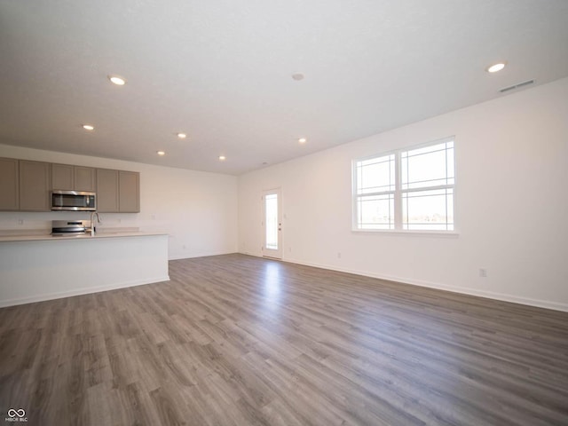 7888 Magnolia St, New Palestine, IN 46163 - unfurnished living room with recessed lighting and wood finished floors