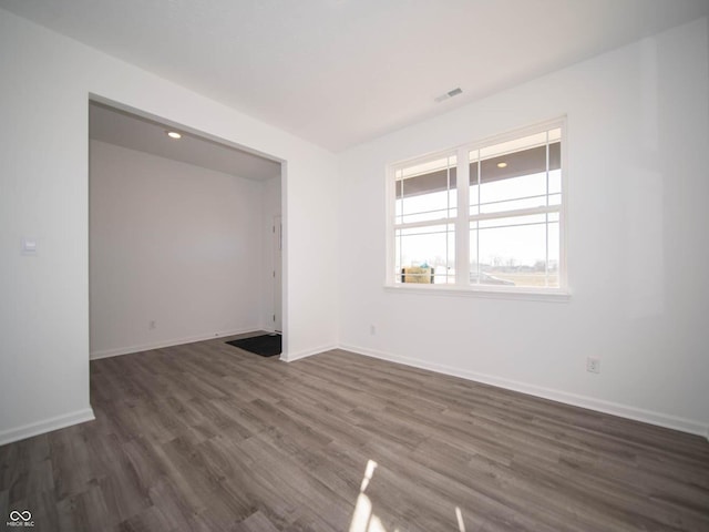 7888 Magnolia St, New Palestine, IN 46163 - spare room featuring dark wood-type flooring and baseboards