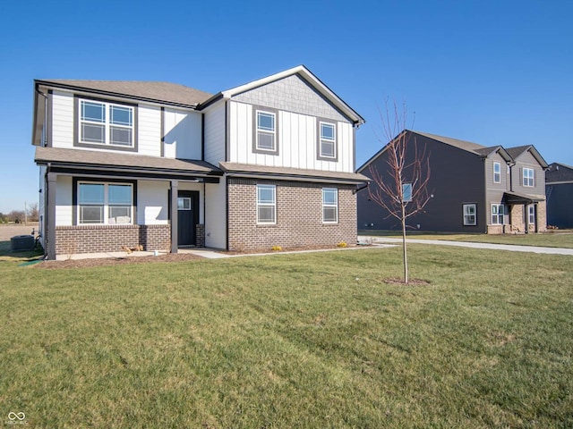 7888 Magnolia St, New Palestine, IN 46163 - view of front of property featuring brick siding, a front lawn, and board and batten siding