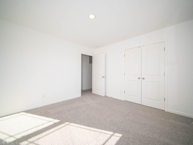 7888 Magnolia St, New Palestine, IN 46163 - unfurnished bedroom featuring light colored carpet and a closet