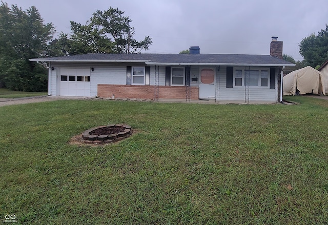 single story home with a fire pit, a garage, and a front yard