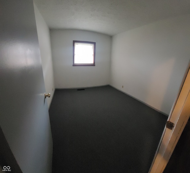 empty room featuring a textured ceiling