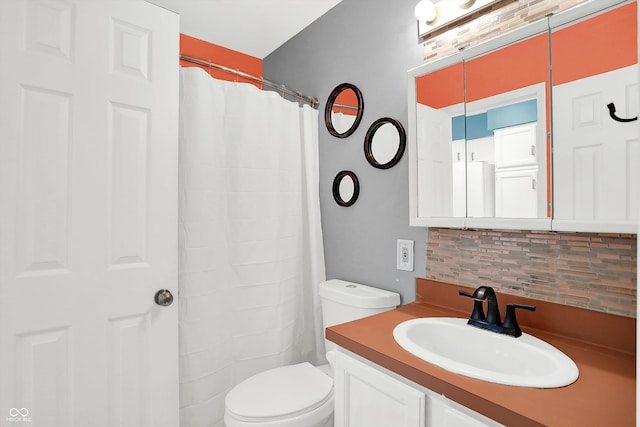 bathroom featuring curtained shower, vanity, toilet, and tasteful backsplash