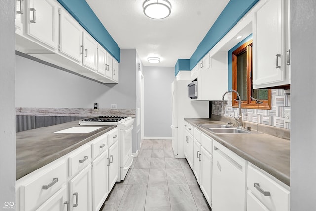 kitchen with white cabinets, white appliances, tasteful backsplash, and sink