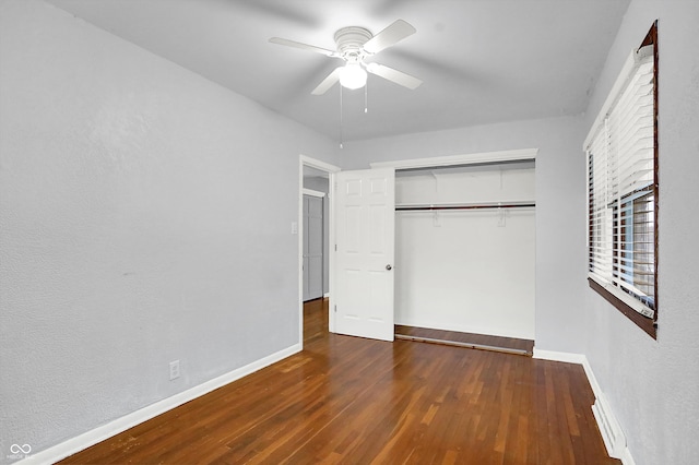 unfurnished bedroom featuring ceiling fan, a closet, and dark hardwood / wood-style floors