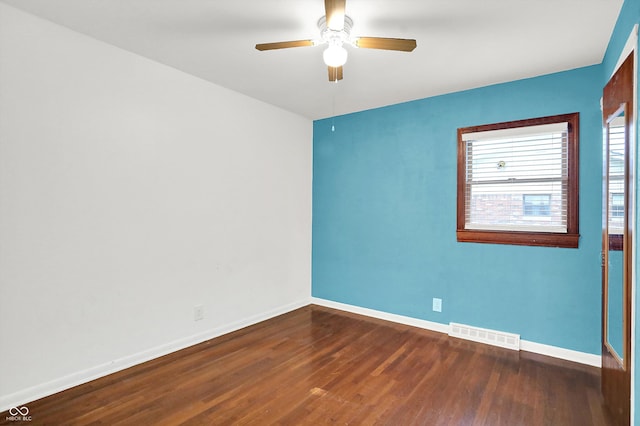 spare room featuring ceiling fan and dark hardwood / wood-style floors