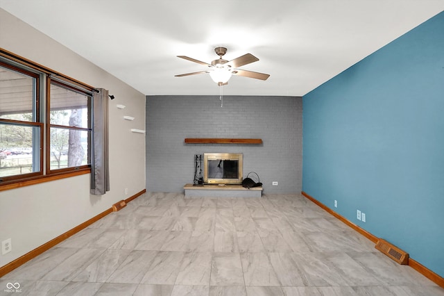 unfurnished living room with a brick fireplace and ceiling fan