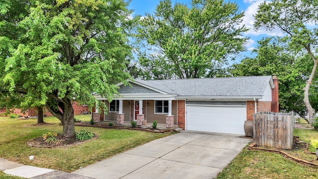 view of front of home featuring a front lawn and a garage