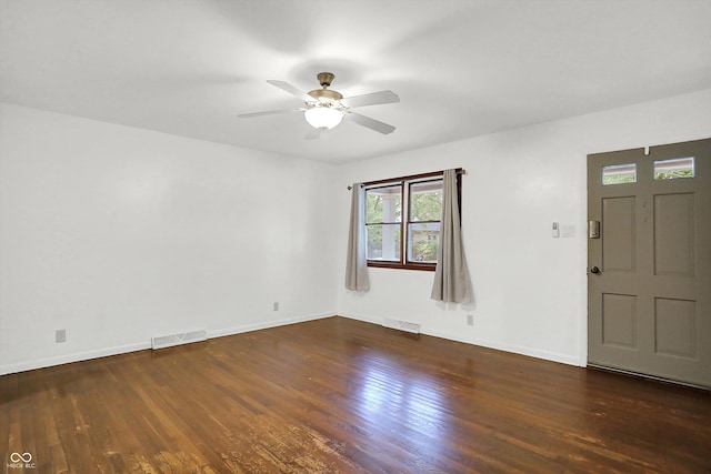 foyer entrance featuring ceiling fan and dark wood-type flooring