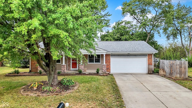 view of front of property featuring a front yard and a garage