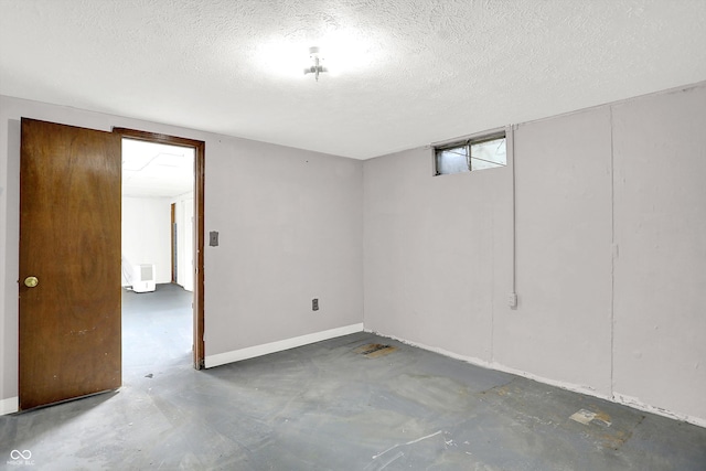 basement featuring a textured ceiling