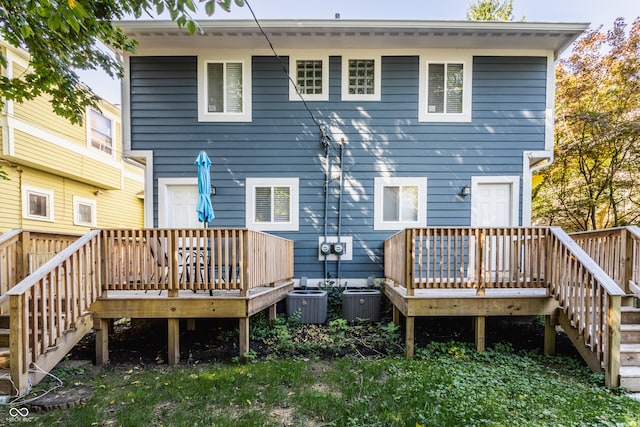 back of property with a deck and central AC unit