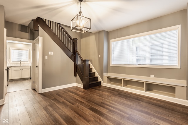 interior space with an inviting chandelier, hardwood / wood-style floors, a healthy amount of sunlight, and sink