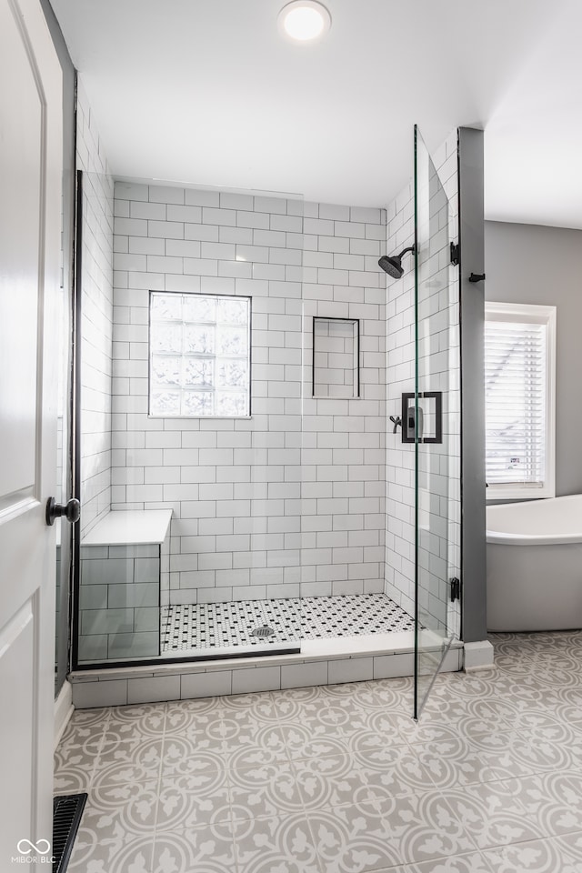 bathroom featuring independent shower and bath