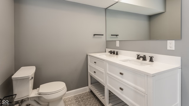 bathroom featuring tile patterned floors, vanity, and toilet