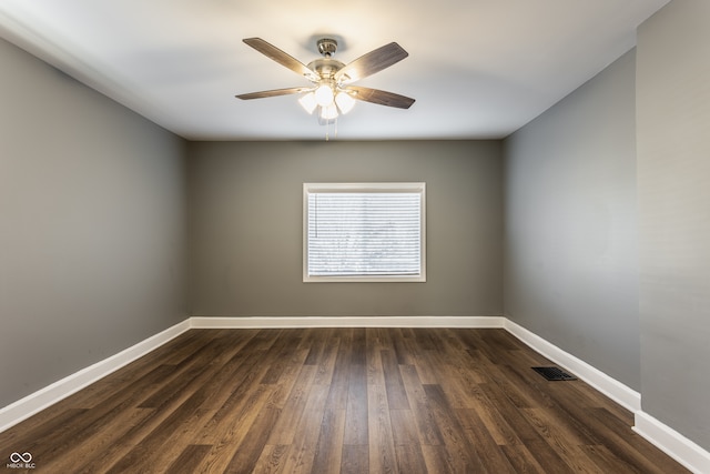 empty room with ceiling fan and dark hardwood / wood-style floors