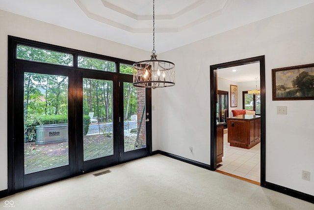 interior space with light carpet and an inviting chandelier