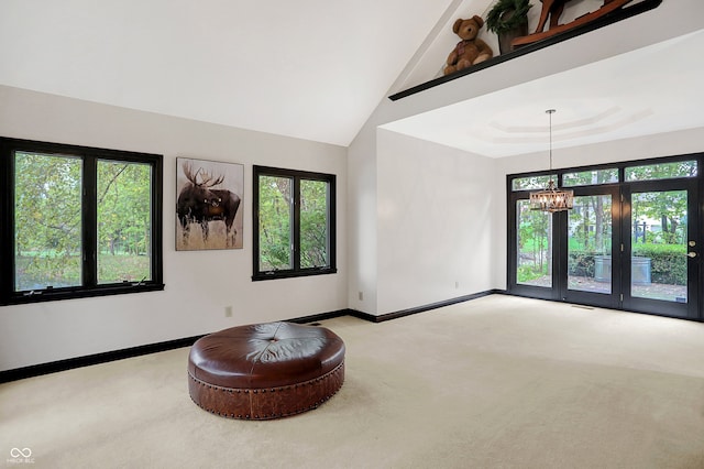 interior space featuring a chandelier, high vaulted ceiling, and a healthy amount of sunlight