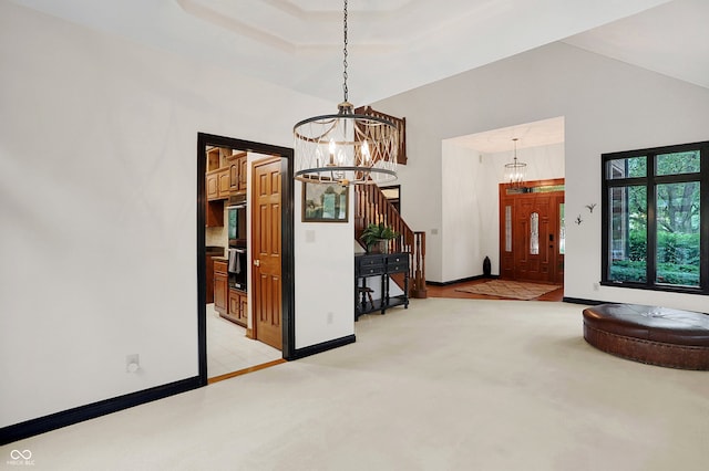 unfurnished dining area with a notable chandelier and light colored carpet