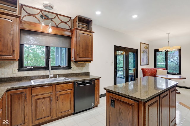 kitchen featuring a healthy amount of sunlight, dishwasher, pendant lighting, and sink