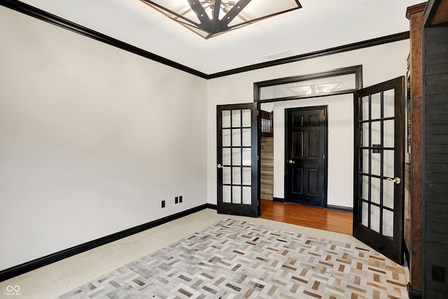 unfurnished room with light wood-type flooring, french doors, and crown molding