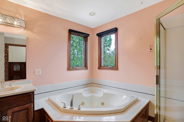 bathroom featuring independent shower and bath and vanity