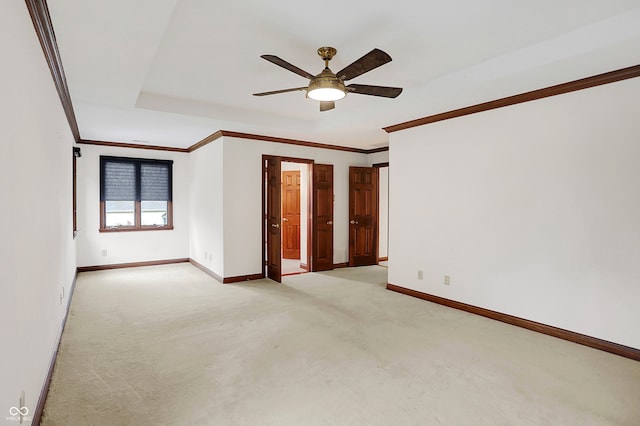 unfurnished room featuring light carpet, ceiling fan, and ornamental molding