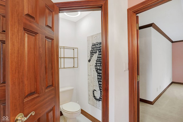 bathroom featuring ornamental molding and toilet