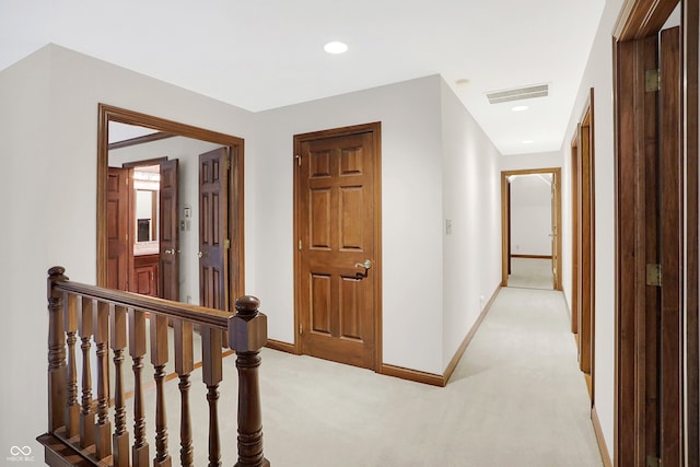 corridor with light colored carpet