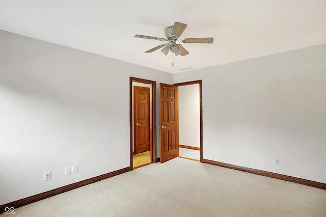 carpeted empty room featuring ceiling fan