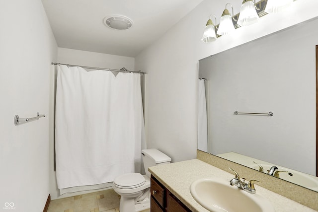 bathroom featuring tile patterned flooring, walk in shower, vanity, and toilet