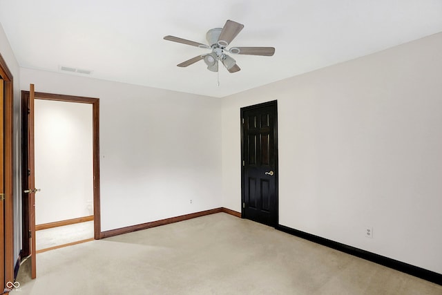 spare room with ceiling fan and carpet